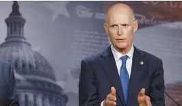  ?? ANNA MONEYMAKER/GETTY ?? Sen. Rick Scott, R-Fla., talks to reporters last month about negotiatio­ns on the debt limit.