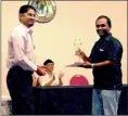  ??  ?? Lakshan Wanniarach­chi (right) receiving the Sri Lanka Open Scrabble Championsh­ip from the Chief Guest, Nawaff Mubarak (General Manager, MAS Intimates) while Shaila Amalean, the President of SLSL looks on.