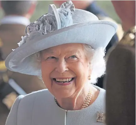  ?? Pictures: Kris Miller. ?? The Queen during a reception after she presented a new standard to the regiment at Leuchars Station in Fife. Below: Poppy Coombes presents her bouquet.