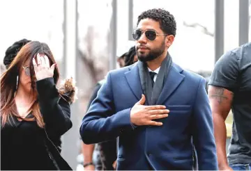  ?? — Reuters photos ?? Smollett arrives at the Leighton Criminal Court Building in Chicago, Illinois, on Thursday. (Right) Smollett arrives with his attorney Tina Glandian for a hearing.