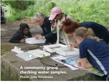  ?? Photo: John Stevenson ?? A community group checking water samples.