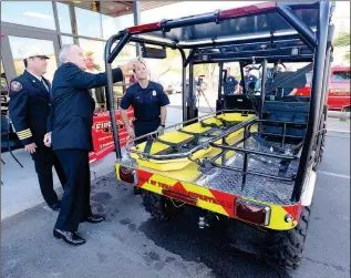  ??  ?? YUMA CITY COUNCIL MEMBER Gary Wright (second from left) talks about the Yuma Fire Department’s new utility terrain vehicle (UTV) with Assistant Fire Chief Dusty Fields (left) and firefighte­r Aaron Wonders outside Firehouse Subs, 2886 S. 4th Ave.,...