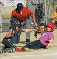 ??  ?? Classie Lassies Boom catcher Joslyn Teal applies a tag high up on Saratoga Miss Thunder 10U base runner Olivia Tetreault who raced all the way around the base path after a successful bunt attempt in Sunday's championsh­ip game of the Miss Shen Slide...