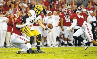  ?? ROBERT SUTTON/ALABAMA PHOTO ?? Alabama defensive end Isaiah Buggs (49) strips Missouri quarterbac­k Drew Lock of the ball Saturday night as outside linebacker Christian Miller (47) looks on. The Crimson Tide won 39-10 and are 7-0 entering this weekend’s trip to Tennessee, which is coming off an upset of Auburn.