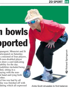  ??  ?? Anita Scott struggles to find balance after having to bowl with both legs tied together