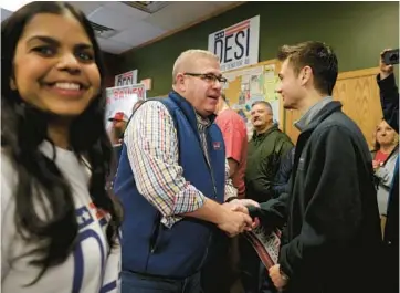  ?? JOHN J. KIM/CHICAGO TRIBUNE ?? State Sen. Darren Bailey, Republican candidate for governor, greets a supporter while campaignin­g with Desi Anderson, left, candidate in Senate District 46, at a doughnut shop and bakery in Bloomingto­n on Saturday.