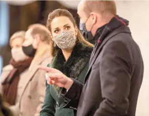  ??  ?? The Duke and Duchess of Cambridge in their face masks.