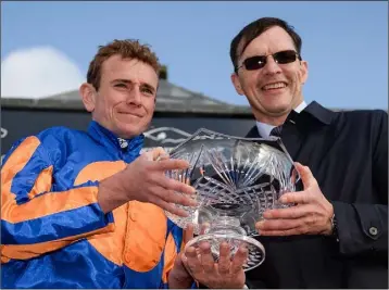  ??  ?? Jockey Ryan Moore and trainer Aidan O’Brien celebrate with the trophy after winning the Comer Group Internatio­nal Irish St Leger on Order of St George during the Longines Irish Champions Weekend 2017 at The Curragh Racecourse in Co Kildare last weekend.