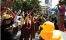  ??  ?? Anti-government protesters flash a threefinge­r salute – a gesture used adopted by protesters from the Hunger Games films – as they gather in support of people detained under the lese-majesty law at a police station in Bangkok. Photograph: Narong Sangnak/ EPA