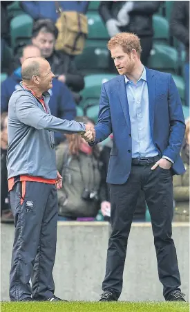  ??  ?? Prince Harry, right, talks to England coach Eddie Jones at Twickenham.