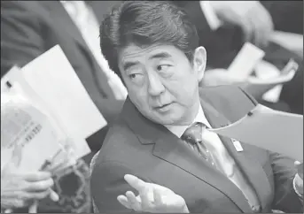  ??  ?? Japanese Prime Minister Shinzo Abe talks with an official during a budget committee meeting at Parliament in Tokyo, Feb
26. (AP)