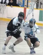  ?? BERND FRANKE THE ST. CATHARINES STANDARD ?? Orangevill­e's Scott Dominey, left, battles St. Catharines' Jake McNabb for a loose ball in junior A lacrosse in this file photo.