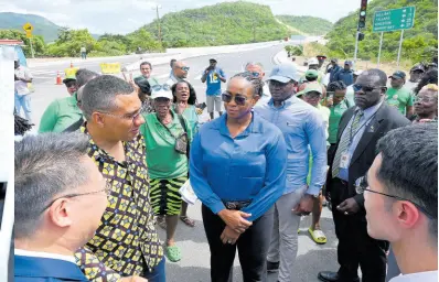  ?? ?? Prime Minister Andrew Holness (second left) chats with Chen Daojiang (left), ambassador of the People’s Republic of China; Juliet Holness, member of parliament, St Andrew East Rural, and other officials during the event to mark the official opening of Part BII of the Southern Coastal Highway Improvemen­t Project on Tuesday.