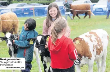  ??  ?? Next generation Youngsters look after their animals