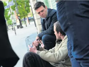  ??  ?? ●●Greater Manchester Mayor Andy Burnham touring the city centre looking at the homeless situation on his first day in office