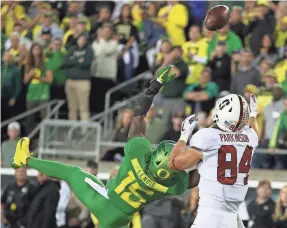  ?? JAIME VALDEZ/USA TODAY SPORTS ?? Stanford tight end Colby Parkinson tips the ball to himself for a TD over Oregon cornerback Deommodore Lenoir in OT.