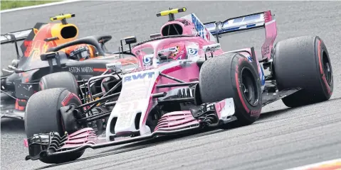  ?? AP ?? Force India’s Esteban Ocon, front, steers his car ahead of Red Bull’s Max Verstappen during the Belgian Grand Prix in August.