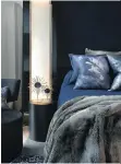  ??  ?? Soothing navy blue linens and headboard accent the black walls and ceiling in the compact and cosy master suite.