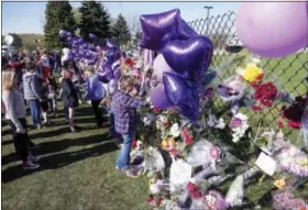  ?? JIM MONE — THE ASSOCIATED PRESS ?? A memorial fence in memory of pop star Prince is lined with flowers and signs at Paisley Park Studios Friday in Chanhassen, Minn. Prince died Thursday at Paisley Park at the age of 57.