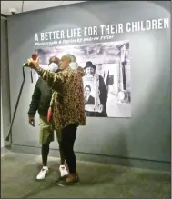  ?? (Special to the Democrat-Gazette/Marcia Schnedler) ?? A couple takes a selfie at the entrance to “A Better Life for Their Children: Julius Rosenwald, Booker T. Washington and the 4,978 Schools That Changed America.”