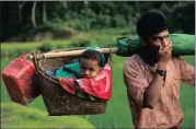  ?? Picture: EPA ?? FLEEING: A Rohingya man carries his baby in a basket as he arrives in Tuangiri, Teknaf, in Bangladesh yesterday. Many of the Rohingya fleeing the violence in Myanmar had walked for days along hilly paths to find refuge in neighbouri­ng Bangladesh.