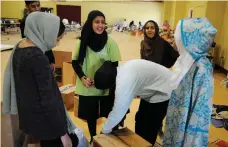  ?? AP ?? At a mosque, volunteers with the Islamic Society of Greater Houston pack donations for the victims of the hurricane