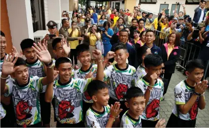  ?? (Soe Zeya Tun/ Reuters) ?? THE 12 SOCCER players and their coach who were rescued from a flooded cave arrive on Wednesday for their news conference in the northern province of Chiang Rai, Thailand.