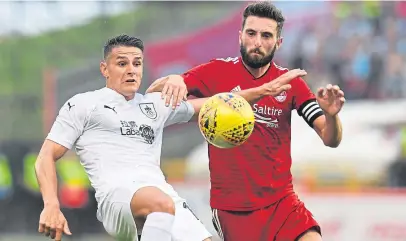  ?? Picture: SNS. ?? Aberdeen’s Graeme Shinnie, right, tracks Burnley’s Ashley Westwood.
