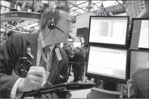  ?? AP/RICHARD DREW ?? Trader Gregory Rowe works Friday on the floor of the New York Stock Exchange.