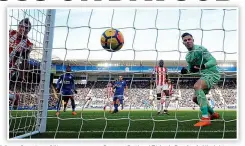  ??  ?? Howler: Stoke’s keeper Butland looks on in horror as he turns the ball into his own goal