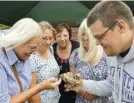  ??  ?? Mark Hamilton shows visitors “Alfie”, a rescued tortoise on the Berkshire Tortoise Club stand