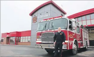  ?? JOSH PENNELL/THE TELEGRAM ?? John Heffernan, acting fire chief for C.B.S., stands outside the new community firehall. Firefighte­r Jennifer Tilley sits behind the wheel of the fire truck.