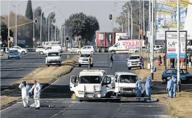  ?? /DARRYL HAMMOND ?? Forensic detectives were back in Boksburg, East Rand, to comb the scene of another cash-intransit heist attempt yesterday, after the famous robbery in March .