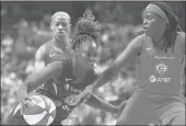  ??  ?? Los Angeles Sparks guard Chelsea Gray (12) drives the ball against Connecticu­t Sun forward Jonquel Jones (35) and guard Jasmine Thomas during the first half of Thursday night’s game at Mohegan Sun Arena.