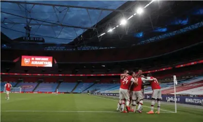 ?? Photograph: Tom Jenkins/NMC Pool/the Guardian ?? Arsenal’s Pierre-Emerick Aubameyang with teammates after scoring during the Arsenal v Manchester City FA Cup semi-final at Wembley Stadium, 18 July 2020.