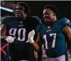  ?? Mitchell Leff/Getty Images ?? The Eagles’ Jordan Davis (90) and Nakobe Dean celebrate after a win over the Vikings.