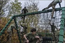  ?? BRENDAN HOFFMAN — THE NEW YORK TIMES ?? Ukrainian Army recruits train in Kyiv in October. More men are avoiding military service amid increasing calls to demobilize exhausted front-line soldiers.