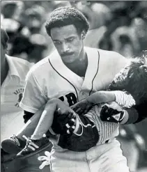  ?? TED GARTLAND / BOSTON HERALD FILE ?? Red Sox left fielder Jim Rice carries Jonathan Keane, then 4, to an ambulance after he was hit in the head by a foul ball at Fenway in August 1982. Keane says the incident taught him life lessons that come back each year on Opening Day.