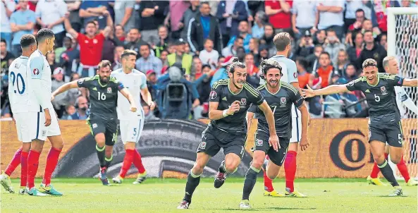  ?? ?? MAGIC MOMENT: Gareth Bale celebrates after putting Wales 1-0 up against England at Euro 2016, which Dylan Levitt watched on his phone.