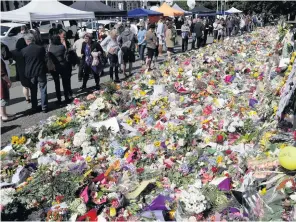  ??  ?? Floral tributes in Christchur­ch following the mosque shootings last week