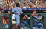  ?? DERIK HAMILTON — THE ASSOCIATED PRESS ?? Philadelph­ia Phillies Roman Quinn (24) is congratula­ted by manager Gabe Kapler after scoring on a double by Cesar Hernandez during a game Thursday night against the Mets.