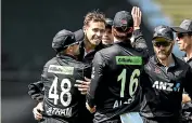  ?? PHOTOSPORT ?? Teammates celebrate with Black Cap Tim Southee after his 200th ODI wicket last night.
