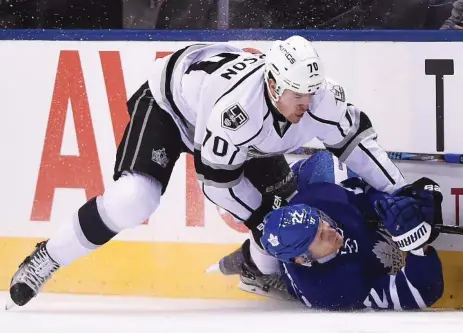  ?? FRANK GUNN/THE CANADIAN PRESS ?? Los Angeles winger Tanner Pearson has Toronto defenceman Nikita Zaitsev pinned in the first period of a 7-0 Kings rout.