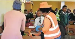  ??  ?? JUST CHECKING: Members of Isolomzi Neighbourh­ood Watch check the bags and belongings of pupils at Van Coller and Nonesi Primary schools for drugs, dangerous weapons and other contraband and found that children as young as grade 3 were involved