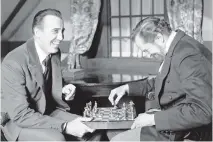  ?? ASSOCIATED PRESS FILES ?? Two masters of film horror — Christophe­r Lee, left, and Vincent Price — share a joke in 1968 while playing chess during a break in the filming of Edgar Allan Poe’s The Oblong Box.
