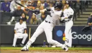  ?? Jeff Roberson / Associated Press ?? The Brewers’ Christian Yelich hits a home run during the first inning of Game 7 of the NLCS against the Los Angeles Dodgers on Oct. 20 in Milwaukee.