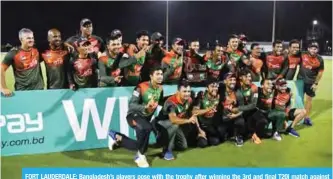  ?? — AFP ?? FORT LAUDERDALE: Bangladesh’s players pose with the trophy after winning the 3rd and final T20i match against West Indies at Central Broward Regional Park Stadium in Fort Lauderdale on August 5, 2018.