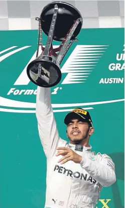  ??  ?? Lewis Hamilton celebrates on the podium after winning his first race since the German Grand Prix in July.