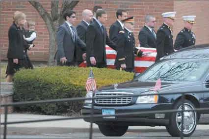  ?? TIM MARTIN/THE DAY ?? An honor guard helps carry the casket of Marine Lt. Col. Thomas Budrejko from St. Mary’s Church in Newington Saturday. Budrejko’s wife, Diana, second from left, carries their 2-year-old son, Andrew.