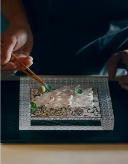  ??  ?? Umu’s ‘Tsukuri’, turbot and gurnard on glass over a card handprinte­d by Chef Yoshi